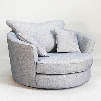 Lot 135 - A modern blue upholstered swivel snuggler...