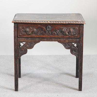 Lot 549 - An 18th century and later carved oak lowboy,...