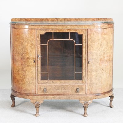 Lot 542 - A 1930s burr walnut side cabinet, on cabriole...