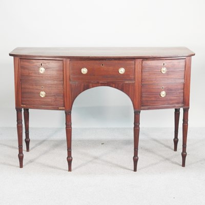 Lot 543 - A Regency mahogany bow front sideboard, on...