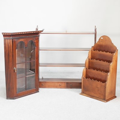 Lot 260 - An Edwardian mahogany four tier hanging shelf,...