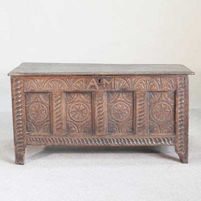 Lot 311 - An 18th century carved oak coffer, with a...