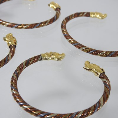 Lot 21 - A set of four Chinese bangles of twisted design