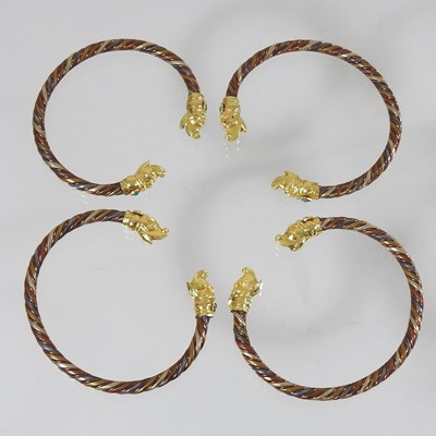 Lot 21 - A set of four Chinese bangles of twisted design