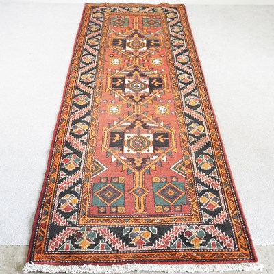 Lot 407 - A Persian heriz runner, with three central...