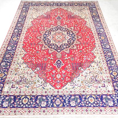 Lot 504 - A large Persian tabriz carpet, with foliate...