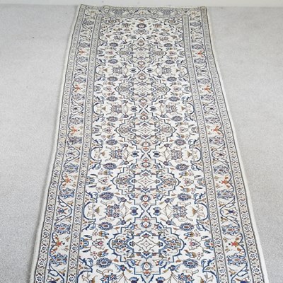Lot 427 - A Persian kashan runner, with foliate designs,...