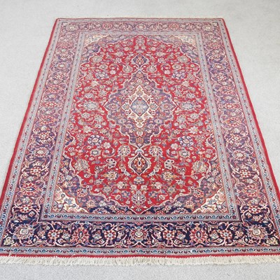 Lot 566 - A large Persian kashan carpet, with scrolling...