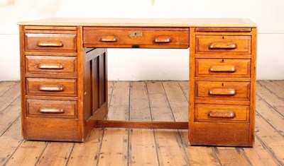 Lot 704 - An early 20th century oak pedestal desk