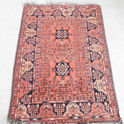 Lot 321 - A Persian rug, with two central lozenges, on a...