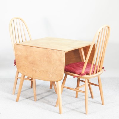 Lot 70 - A 1970s Ercol light elm drop leaf dining table,...