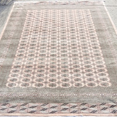 Lot 415 - A large Bokhara carpet, with eight rows of...