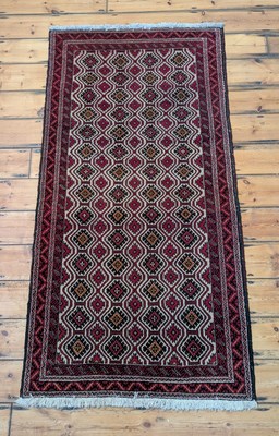 Lot 734 - A Turkish rug, the red medallions on a cream...