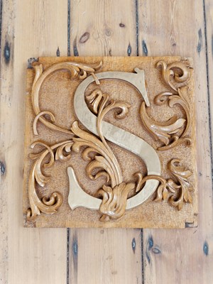 Lot 692 - A carved oak panel decorated with the letter S...