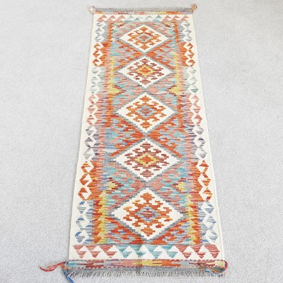 Lot 101 - A Persian kilim runner, with a row of four...