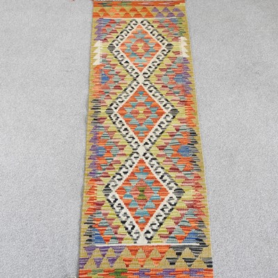 Lot 382 - A Persian kilim runner, with three central...