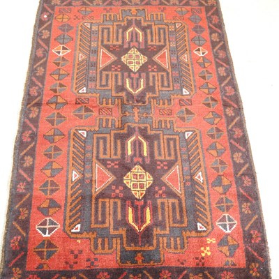 Lot 259 - A baluchi rug, with two central medallions, on...