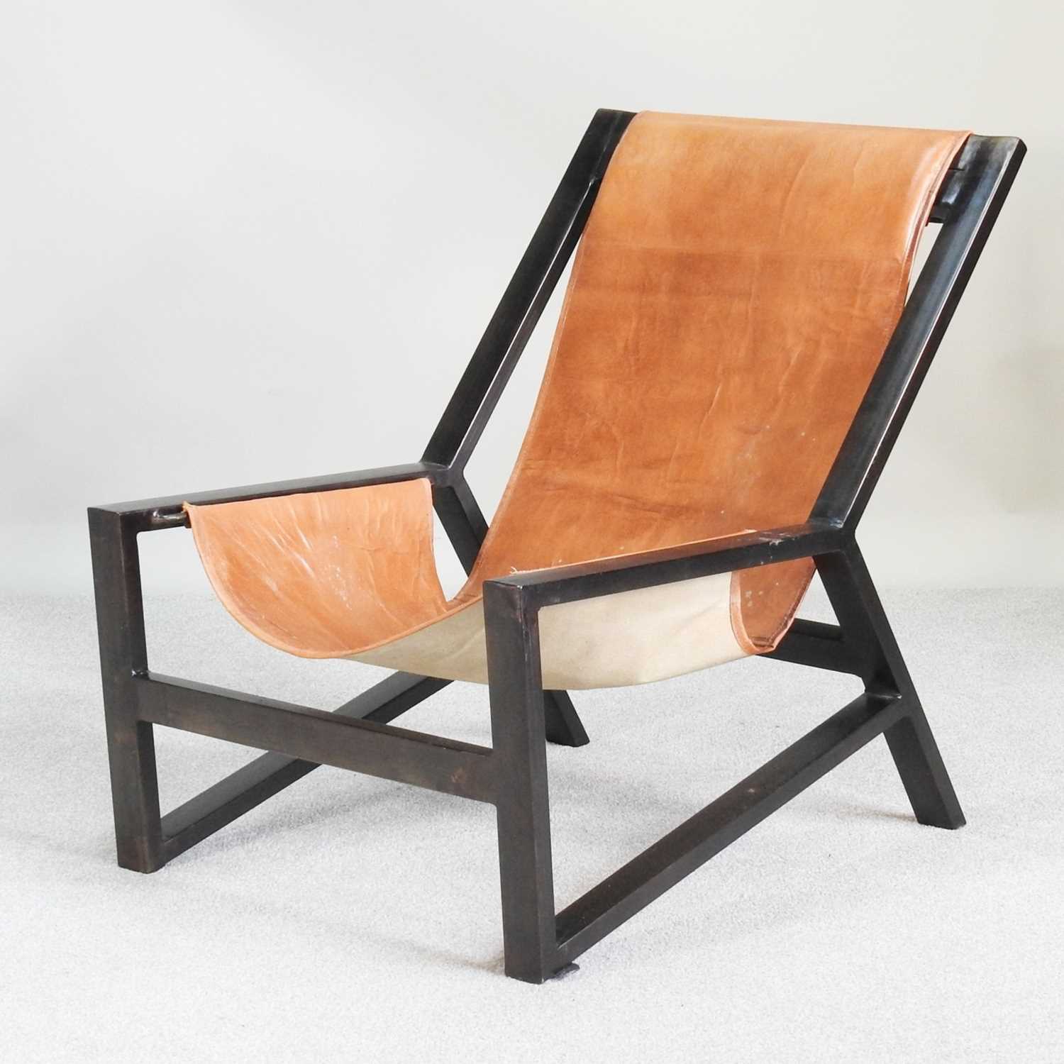 Lot 17 - A Nkuku mid century leather sling chair, with...