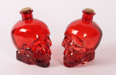Lot 641 - A pair of red glass bottles, in the form of...