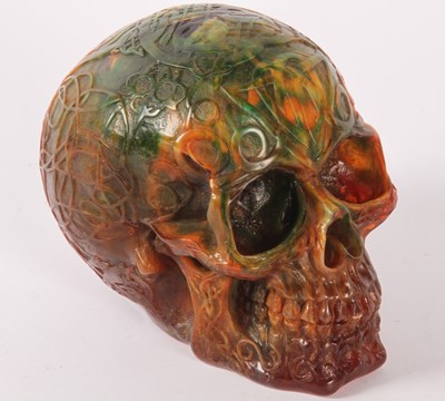 Lot 604 - An amber coloured model of a skull