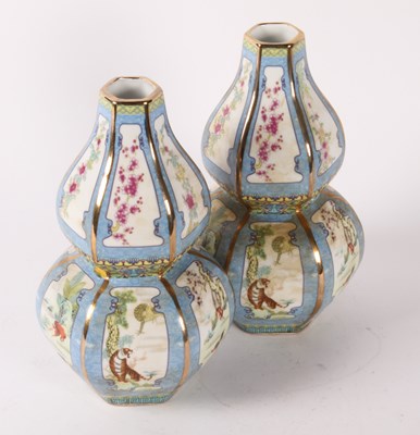 Lot 516 - A pair of Chinese porcelain double gourd vases