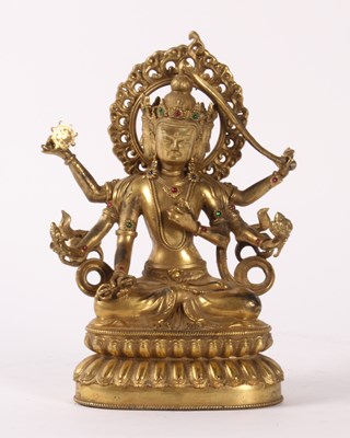 Lot 52 - A Chinese gilt bronze figure of a deity, shown...