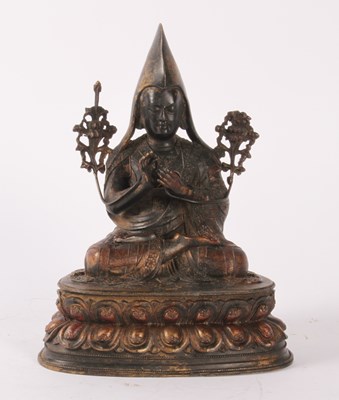 Lot 276 - A Chinese bronze figure of a deity, shown seated