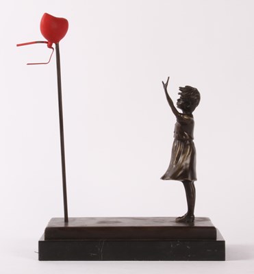 Lot 726 - After Banksy, a bronze figure of a girl and...