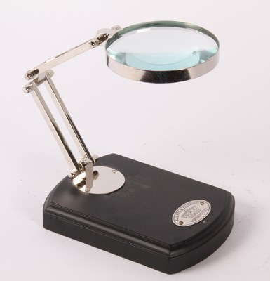 Lot 619 - A magnifying glass, on stand