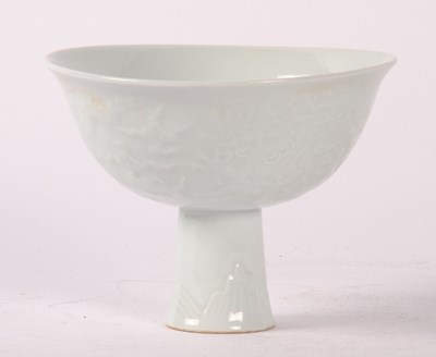 Lot 311 - A Chinese white porcelain stem cup, underglaze...