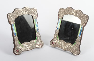 Lot 98 - A pair of silver and enamel-framed photograph...