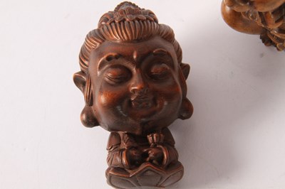 Lot 85 - A Japanese wooden netsuke, in the form of a...