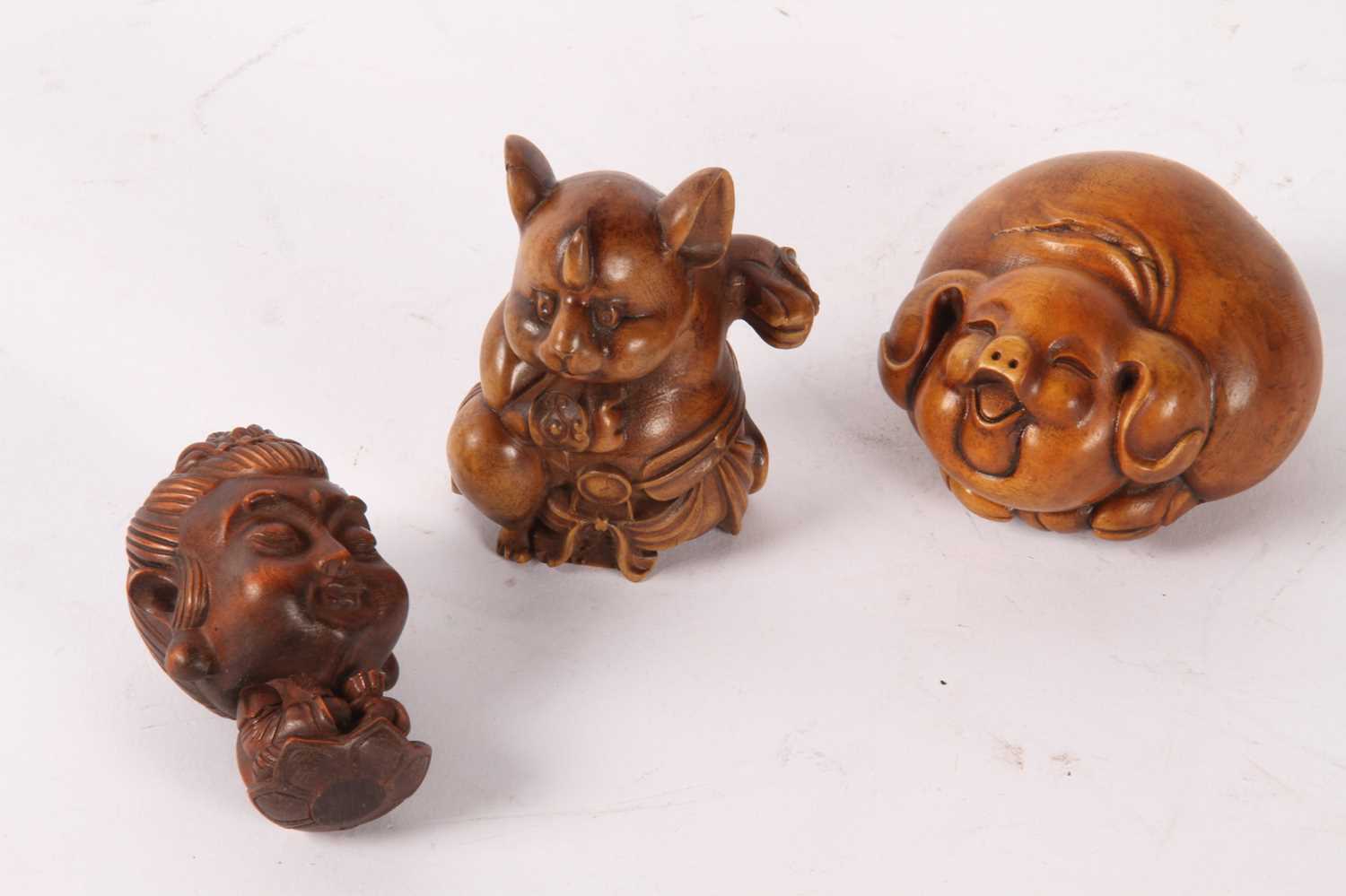 Lot 85 - A Japanese wooden netsuke, in the form of a...