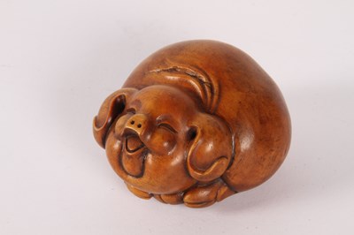 Lot 85 - A Japanese wooden netsuke, in the form of a...