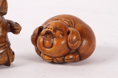 Lot 85 - A Japanese wooden netsuke, in the form of a...