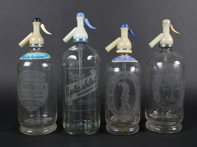 Lot 693 - A set of four vintage glass soda bottles