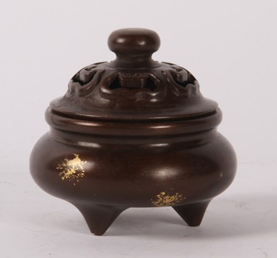 Lot 199 - A Chinese bronze gold splash decorated lidded...