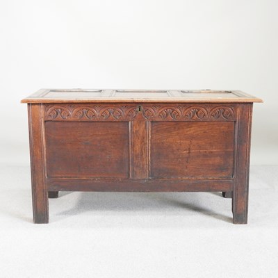 Lot 273 - An 18th century carved oak coffer, with a...