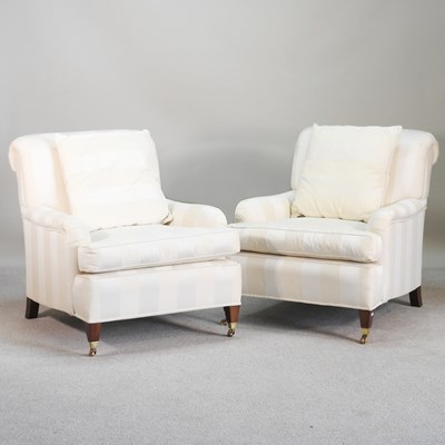 Lot 489 - A pair of cream upholstered armchairs, on...