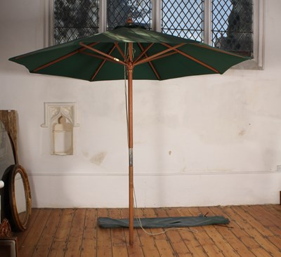 Lot 529 - A folding parasol, with cover, together with...