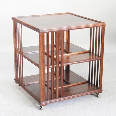 Lot 517 - An Edwardian style teak revolving bookcase,...