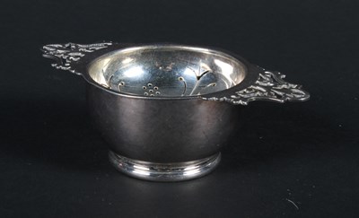 Lot 50 - An early 20th century silver tea strainer and...