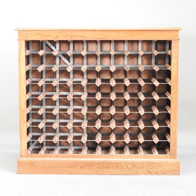 Lot 372 - A hand made light oak wine rack, on a plinth base