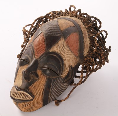Lot 391 - An African carved wooden Chokwe Rasta mask,...