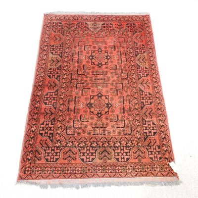 Lot 481 - A Persian rug, with all over designs, on red...