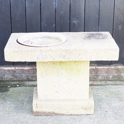 Lot 99 - A cast stone bird table, on a pedestal base