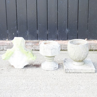 Lot 438 - A cast stone garden urn, on a plinth base,...