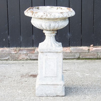 Lot 24 - A cast stone garden urn, on a pedestal base,...