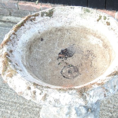 Lot 24 - A cast stone garden urn, on a pedestal base,...
