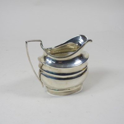 Lot 39 - A George III silver cream jug, London 1803,...